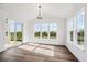 Bright dining room with large windows and sliding glass doors offering natural light and outdoor views at 5614 Riverbend Ave, Firestone, CO 80504