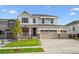 Beautiful two-story home with a three-car garage and well-manicured lawn on a sunny day at 5614 Riverbend Ave, Firestone, CO 80504