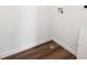 Compact laundry room area featuring wood-look flooring and convenient hookups for a washer and dryer at 5614 Riverbend Ave, Firestone, CO 80504