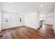 Spacious living room with hardwood floors, three windows, and recessed lighting throughout the room at 5614 Riverbend Ave, Firestone, CO 80504