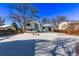 Snow-covered backyard with a view of the house at 2142 Sherri Mar St, Longmont, CO 80501