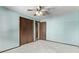 Another bedroom with light blue walls, carpet, and double closets at 2142 Sherri Mar St, Longmont, CO 80501