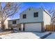 Two-story house with a light-blue exterior, a two-car garage, and a snow-covered front yard at 2142 Sherri Mar St, Longmont, CO 80501