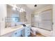 Bathroom featuring a shower with sliding glass doors, a vanity, and a toilet at 775 S Alton Way # 3D, Denver, CO 80247