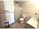 Bright bathroom featuring a shower with glass doors, modern toilet, sink and floating shelves at 775 S Alton Way # 3D, Denver, CO 80247