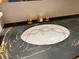Unique gold hardware and marbled black countertop adds a decorative touch to bathroom sink at 775 S Alton Way # 3D, Denver, CO 80247