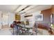 Dining room with a glass-topped table, ornate chairs, decorative lighting, and unique wall art at 775 S Alton Way # 3D, Denver, CO 80247