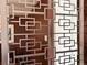Entryway with a decorative mid-century screen separating the entry from the living room at 775 S Alton Way # 3D, Denver, CO 80247