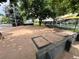 Outdoor horseshoe pit area surrounded by lush trees and picnic tables, perfect for Gathering activities at 775 S Alton Way # 3D, Denver, CO 80247