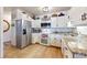 Well-lit kitchen with stainless steel appliances, white cabinets, granite countertops, and hardwood floors at 775 S Alton Way # 3D, Denver, CO 80247