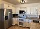 Bright kitchen featuring stainless steel appliances, white cabinetry, and granite countertops at 775 S Alton Way # 3D, Denver, CO 80247