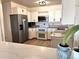 Well-lit kitchen with stainless steel appliances, white cabinets, granite countertops, and hardwood floors at 775 S Alton Way # 3D, Denver, CO 80247