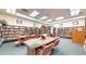 Serene library with floor-to-ceiling bookshelves, tables, and reading chairs, perfect for quiet study at 775 S Alton Way # 3D, Denver, CO 80247