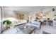 Bright living room with comfortable seating, a modern coffee table, and an open layout to the kitchen at 775 S Alton Way # 3D, Denver, CO 80247