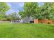 Spacious backyard with lush lawn, inviting deck, hot tub and mature trees at 11870 Cattle Ln, Parker, CO 80134