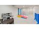 Finished basement with carpet featuring play area with gymnastic equipment and toy kitchen at 11870 Cattle Ln, Parker, CO 80134