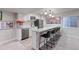 Basement bar featuring white cabinets, modern appliances, pendant lighting, and seating for four at 11870 Cattle Ln, Parker, CO 80134