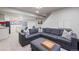 Finished basement with plush carpet, a large sectional, and a bar with white cabinets at 11870 Cattle Ln, Parker, CO 80134