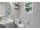 Charming powder bathroom featuring pedestal sink, decorative wall shelves and neutral paint color at 11870 Cattle Ln, Parker, CO 80134