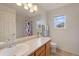 Bright bathroom with a large mirror, a window, and shower with floral curtains at 11870 Cattle Ln, Parker, CO 80134