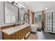 Elegant main bathroom featuring double sinks, a soaking tub, and a walk-in shower with neutral finishes at 11870 Cattle Ln, Parker, CO 80134