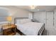 Cozy bedroom features a large bed, wood nightstand and comfortable seating area at 11870 Cattle Ln, Parker, CO 80134