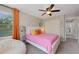 This bright bedroom includes a ceiling fan, window, plush carpet and a closet for easy storage at 11870 Cattle Ln, Parker, CO 80134