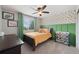 Bedroom with plush carpet, a window, a ceiling fan, and sunflower wallpaper at 11870 Cattle Ln, Parker, CO 80134