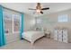 A bright bedroom with plush carpet, a ceiling fan, and a sunny window at 11870 Cattle Ln, Parker, CO 80134