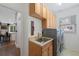 Functional laundry room includes cabinetry for storage, stainless steel sink and modern washer/dryer at 11870 Cattle Ln, Parker, CO 80134