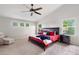Spacious main bedroom features high ceilings, a ceiling fan, plush carpet, and bright windows at 11870 Cattle Ln, Parker, CO 80134