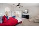 Comfortable main bedroom with plush carpet, ceiling fan, dresser with wall mounted TV, and lots of light at 11870 Cattle Ln, Parker, CO 80134