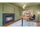 Modern home office features a fireplace, wooden desk, contemporary lighting, and an inviting atmosphere at 11870 Cattle Ln, Parker, CO 80134