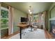Stylish home office features a large desk, modern lighting, fireplace and windows with backyard views at 11870 Cattle Ln, Parker, CO 80134