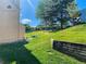 A view of the backyard which features healthy green grass, landscaping and a wooden retaining wall at 9512 W Ontario Dr, Littleton, CO 80128