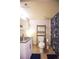 Cozy bathroom with tile floors, white vanity, and floral shower curtain at 9512 W Ontario Dr, Littleton, CO 80128
