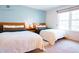 Bright bedroom featuring two beds, a large window, and ample natural light for a comfortable and airy feel at 9512 W Ontario Dr, Littleton, CO 80128