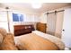 Cozy bedroom with modern furniture, a decorative door, and soft natural light at 9512 W Ontario Dr, Littleton, CO 80128