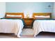 Cozy bedroom featuring two twin beds with wooden headboards and soft lighting for a relaxing atmosphere at 9512 W Ontario Dr, Littleton, CO 80128