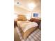 Comfortable bedroom featuring a queen size bed, a piano, and a patterned rug at 9512 W Ontario Dr, Littleton, CO 80128