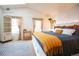 Inviting bedroom features ample natural light, modern decor, and a comfortable bed with blue and yellow accents at 9512 W Ontario Dr, Littleton, CO 80128