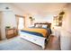 Bright bedroom with a white storage bed, decor, and large windows offers a comfortable and inviting space at 9512 W Ontario Dr, Littleton, CO 80128