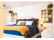 Cozy bedroom features unique decor and a comfortable bed with blue bedding and a yellow throw blanket at 9512 W Ontario Dr, Littleton, CO 80128