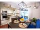 Dining room with white cabinets, stainless steel appliances, a modern light fixture, and access to a patio at 9512 W Ontario Dr, Littleton, CO 80128