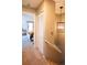 Hallway leading to a bedroom with closet, featuring a modern light fixture for a stylish and functional space at 9512 W Ontario Dr, Littleton, CO 80128