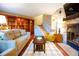 Spacious living room with hardwood floors, a fireplace, and built-in shelving at 9512 W Ontario Dr, Littleton, CO 80128