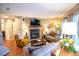 Comfortable living room featuring a stone fireplace, hardwood floors, and ample seating at 9512 W Ontario Dr, Littleton, CO 80128