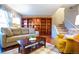 Inviting living room showcasing a built-in bookcase, hardwood floors, and a comfortable layout at 9512 W Ontario Dr, Littleton, CO 80128