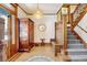 Grand entryway with hardwood floors, a wooden staircase, and antique furniture at 1606 Adams St, Denver, CO 80206