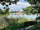 Park bench overlooking a calm lake and city skyline at 1606 Adams St, Denver, CO 80206